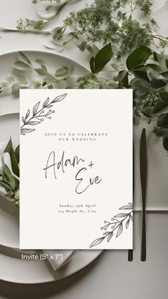 the wedding stationery is laid out on a table with greenery and silverware