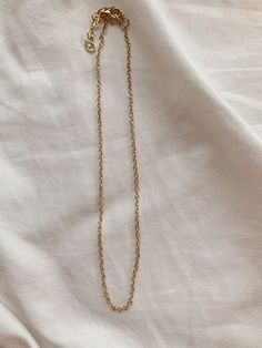 This necklace is 14 inches long and has a 2-inch extender chain so it can be adjusted to be 14-16 inches long! Adjustable Delicate Chain Charm Choker, Adjustable Delicate Chain Choker Charm Necklaces, Dainty Necklace With Round Pendant And Gold Chain, Adjustable Heart Pendant Necklace, Adjustable Choker Necklace With Delicate Chain, Adjustable Charm Choker Necklaces With Chain, Dainty Adjustable Initial Pendant Necklaces, Minimalist Gold Chain Pendant Necklace, Metal Chain Link Necklace With Adjustable Chain