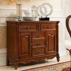 a wooden sideboard sitting in front of a mirror