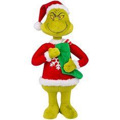 the grin plush toy is wearing a santa hat and holding a green christmas stocking