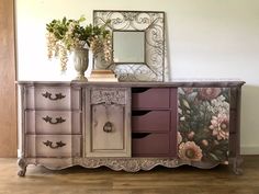 an old dresser with flowers painted on it