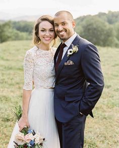 a bride and groom standing in tall grass