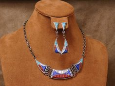 "Beautiful vintage sterling silver inlay necklace with sterling inlay earrings. The center inlay piece measures 4 1/2\" wide and 3/4\" tall at the tallest point. The whole necklace and chain measure 17 1/4\" long. The necklace is marked \"S\" with an \"E\" and C\" inside it, plus \"Zuni Sterling\" on the bottom of it. The earrings measure 2 1/4\" tall and 6/8\" wide at it's widest point. Both earrings are stamped the same way the necklace is. The inlay consists of coral, turquoise, mother of pea Mabe Pearl Necklace, Mabe Pearl, Jasper Necklace, Necklace And Earrings Set, Coral Turquoise, Butterfly Necklace, Necklace And Earrings, Turquoise Pendant, Silver Turquoise