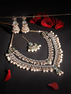 This jewellery set consists of a necklace, maangtika and a pair of earringsGold-plated layered necklace, has white & Green Kundan stone-studded & Pearls beaded detailsSecured with a drawstring closureA pair of matching drop earrings, each secured with a post-and-back closureMatching maangtika secured with hook closure Size & Fit Necklace Length-51 cmEarring Length-8 cm EachMaangtikka Length-12 cmProduct Weight-179 grams Material & Care Material: AlloyPlating: Gold-platedStone Type: Kundan & PearlsCare InstructionWipe your jewellery with a soft cloth after every useAlways store your jewellery in a flat box to avoid accidental scratchesKeep sprays and perfumes away from your jewelleryDo not soak your jewellery in waterClean your jewellery using a soft brush, dipped in jewellery cleaning solu Festive White Jewelry With Stone Work, Festive Silver Kundan Beaded Necklace, White Necklace With Mirror Work For Festivals, White Kundan Beaded Jewelry Sets, White Beaded Kundan Jewelry Sets, White Necklace With Mirror Work For Celebrations, White Necklace With Mirror Work For Festive Season, White Jewelry Sets With Mirror Work For Festivals, Traditional White Jewelry With Mirror Work