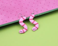 "Hi CutiePie, We're funny happy worms earrings. We're earrings created from polymer clay without using any molds and completely handmade. We can be a funny gift for people of all ages. We'll always cheers You up and will bring a smile on your face. Our dimensions are: Length 1.6\" ( or 4 cm. ) Width 0.8\" ( or 2 cm. ) ❀We come in a pretty box but please note in the event that several items are purchased all of us will ship in one box. ❀ Because we're made by hand, we may differ slightly than sho Worm Polymer Clay, Weird Polymer Clay Earrings, Worm Earrings, Polymer Clay Worm, Funny Earrings Diy, Goblincore Earrings, Funny Polymer Clay Earrings, Funny Clay Earrings, Funny Earrings For Gift