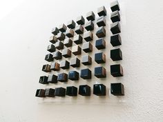 there is a wall sculpture made out of black squares