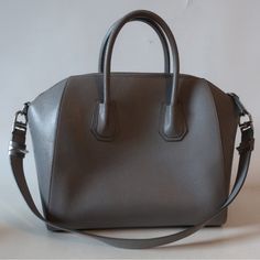 Silver-Toned Givenchy Hardware Goatskin 1interior Slip Pocket 1interior Slip Media Pocket 11 Regular Zip Interior Pocket Top Width Is 16” Base Width Is 13.1” Depth Is 7.5” Height Is 11.2” Strap Drop Is 11.2” Handle Drop Is 3.3” Pic With Model Is To Show Bag Size Only. Wear On Top Handles, Bag Edges, And Some Of The Piping. Scratch Between Back Handle Notches. Minor Scratch Near Front Bag Edge. Lining Has Marks That May Clean Out. Otherwise In Amazing Condition. Interior Is Black. A Gorgeous Pre- High-end Silver Rectangular Shoulder Bag, Luxury Gray Rectangular Satchel, Luxury Satchel With Silver-tone Hardware, Luxury Satchel With Silver-tone Hardware For Daily Use, Luxury Satchel With Silver-tone Hardware As Shoulder Bag, Luxury Shoulder Satchel With Silver-tone Hardware, Luxury Handheld Satchel With Silver-tone Hardware, Elegant Gray Rectangular Satchel, Chic Silver Shoulder Bag For Business