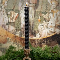 a black candle sitting on top of a table