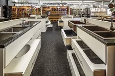 the inside of a store filled with lots of counter tops and sink basins in it