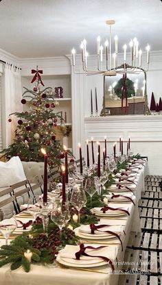 a dining room table set for christmas dinner with candles and decorations on the long table