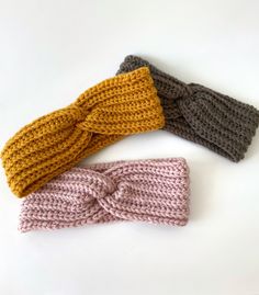 three crocheted headbands on a white surface, one with a knot