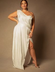 a woman in a white dress posing for the camera with her hands on her hips