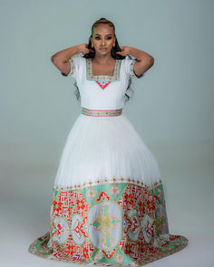 Indulge in the epitome of elegance with our breathtaking Habesha Kemis, a fusion of tradition and contemporary style. Our Habesha dress exudes timeless beauty and sophistication, adorned with intricate patterns that capture the essence of Ethiopian culture. Ceremonial Fitted Gown With Traditional Patterns, Elegant Embroidered Dress With Traditional Patterns, Floor-length Gown With Traditional Patterns For Ceremonies, Elegant Dresses With Traditional Patterns For Ceremonies, Traditional Embellished Wedding Dress For Eid, Embellished Traditional Wedding Dress For Eid, Traditional White Embellished Wedding Dress, Traditional Patterned Gown For Eid Wedding, Traditional Patterned Gown For Wedding And Eid