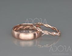 two gold wedding bands with diamonds on each band, set in 18k rose gold