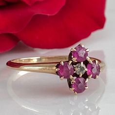 Details: Super sweet Victorian ring with diamond and pink/red rubies. The setting reminds me of flower. The ring is 14K rose gold, and has been tested. There are no markings on the interior of the band. There are four 3.25mm rubies and one 2mm diamond. Please ask all necessary questions prior to placing an order. Measurements: The size is 7 1/4 US and can be sized for a fee. Condition: The overall all condition of this ring is very good. Pink Ruby Ring With Single Cut Diamonds, Antique Pink Ruby Ring With Rose Cut Diamonds, Vintage Pink Ruby Ring With Diamonds, Victorian Rose Gold Ruby Ring For Anniversary, Victorian Pink Ruby Ring For Anniversary, Vintage Pink Diamond Ruby Ring, Pink Victorian Ruby Ring For Anniversary, Rose Gold Ruby Ring Hallmarked Fine Jewelry, Pink Ruby Wedding Ring Stamped 14k