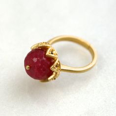 A stunning and luminous 12mm raspberry red ruby stone is set into a 22k gold over sterling vermeil setting. This stone absolutely glows from every single angle. The size is fully adjustable on the very comfortable band. An absolute one and only fine gemstone ring. Adjustable Elegant Ruby Ring, Gold Faceted Ruby Ring, Gold Faceted Ruby Ring For Anniversary, Elegant Adjustable Gold Ruby Ring, Adjustable Ruby Ring Gift, Adjustable Yellow Gold Ruby Ring, Adjustable Gold Ruby Ring Gift, Spiritual Gold Rings With Ruby, Spiritual Gold Ruby Rings