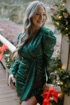 Emerald Up To Something Dress You could definitely be up to somethin' in this dress! Hit all of the holiday parties and any night out will be memorable in this stretchy and fully-lined stunner. The glittering green fabric is sparkle from top to bottom, but it is also covered with tiny gold tone sequins that give it an overall gold sheen. The set elastic waistband and ruching on the skirt hug the body. The plunging neckline is perfect for displaying the newest jewelry. The zippered back keeps the Fitted V-neck Sequin Dress For Festive Occasions, Glamorous Long Sleeve Sequin Dress For Christmas, Green Fitted Mini Dress For Party Season, Green Fitted Mini Dress For Party, Fitted Green Mini Dress For Party Season, Fitted Green Mini Dress For Party, Christmas Long Sleeve Sequin Dress For Night Out, Glamorous Glitter Mini Dress For Winter, Glitter Dress For Night Out In Fall