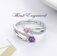 Personalized 2 Stone Mother's Ring Heart Birthstones 2 Engraved Names This ring is made of .925 sterling silver. You can choose 2 engraved names and 2 birthstones. Enter like this, please- Birthstone 1- Name 1- Birthstone 2- Name 2- Inner engraving-  Names must be 10 characters or less and inner engraving 18 characters or less We hand-make this piece once the order is placed.  This takes 3-5 business days during the normal time of year but can take up to 10 business days if it is the holiday sea Engraved Silver Birthstone Ring For Anniversary, Silver Engraved Promise Ring With Birthstone, Silver Engraved Birthstone Ring For Anniversary, Personalized Heart Birthstone Ring In Sterling Silver, Personalized Silver Birthstone Ring For Anniversary, Personalized Silver Birthstone Ring For Valentine's Day, Customizable Silver Birthstone Promise Ring, Engraved Sterling Silver Birthstone Ring For Promise, Engraved Sterling Silver Birthstone Promise Ring