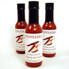 three bottles of pepperikia hot sauce on a white background