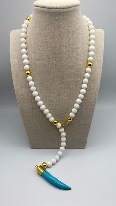 22 inch white quartz beaded, lariat style statement necklace with gold vermeil accent beads and a turquoise and gold vermeil horn pendant. White Beaded Chain Lariat Necklace, White Lariat Necklace With Beaded Chain, White Gemstone Beads Lariat Necklace, White Lariat Necklace With Gemstone Beads, White Lariat Necklace With Natural Stones, White Single Strand Spiritual Necklace, White Spiritual Lariat Necklace, Spiritual Single Strand White Necklace, Spiritual White Lariat Necklace