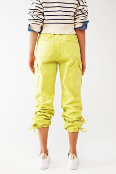 Introducing our Cargo Pants with Tassel Ends in Lime, a stylish and comfortable choice for a casual yet fashionable look. These ankle-length pants are designed to provide a relaxed and effortless fit. With a relaxed fit and straight leg, these cargo pants offer a laid-back style that is perfect for everyday wear. The comfortable fit allows for easy movement, while the straight leg design adds a touch of versatility. Crafted from stretch denim, these pants provide a comfortable and flexible feel. Stretch Denim Fabric, Effortless Outfit, Denim Pocket, Pants Fit, Casual Belt, Modern Trend, Perfect Wardrobe, Fuchsia Color, Fast Fashion