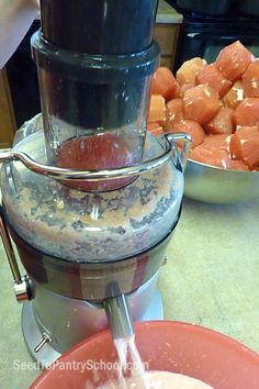 a person pouring something into a bowl with carrots and other food in the background