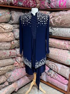 Midnight blue exclusive embellished with intricate pearl, stone, zari and cutdana work, this sherwani speaks volume of class. Commingled with blue color kurta for the complete ensemble. This jacket sherwani is a unique style that we loved. Even the color is fresh and looks royal. Size: 42,44 Occasion: Wedding Ceremony or Reception WASH CARE INSTRUCTIONS - Please Dry clean only when it is applicable. Slight color variation is possible due to digital photography. Ready to Ship! Designer Blue Traditional Wear With Dabka Work, Designer Blue Nehru Jacket With Traditional Drape, Designer Nehru Jacket With Mirror Work For Eid, Designer Blue Sets With Dabka Detailing, Designer Bandhgala With Mirror Work, Designer Blue Sherwani With Dabka Work, Designer Blue Traditional Wear For Festive Season, Designer Blue Bandhgala With Zari Work, Blue Bandhgala With Mirror Work For Festive Occasions