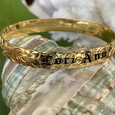 Locally Handmade. Please Allow 3-5 weeks for delivery. You will love and cherish these Custom Hawaiian Scroll Bangles. The Hawaiian Scroll Design is hand engraved by a local Master Engraver. Free Engraved Name in Black Enamel or Raised Gold lettering is included! It is beautiful, one-of-a-kind and custom made especially for YOU!! Our customers tell us these look just like the solid gold pieces they have - but we've made them affordable with 14K Gold Plating over .925 Sterling Silver. 10mm ~ $249 Heirloom Adjustable Bracelets For Ceremonial Occasions, Adjustable Heirloom Bracelet For Ceremonial Occasion, Heirloom Style Adjustable Ceremonial Bracelet, Adjustable Heirloom Ceremonial Bracelet, Engraved Bangle Bracelet For Personalized Gift, Round Bracelets With Engraving Option For Personalized Gifts, Traditional Ceremonial Jewelry With Engraving Option, Traditional Engraved Ring With Engraving Option, Heirloom Etched Bracelets For Anniversary