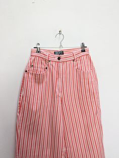 "a vintage pair of red and white stripe trousers ✿ IMPORTANT INFORMATION: * excellent vintage condition * material: 100% cotton * size: extra-small - please check exact measurements below (they're there for your benefit!) * garment care: machine washable ✿ MEASUREMENTS (taken while item is lying flat, some measurements will need to be doubled): * waist: 12\" (30cm) * hips: 18.5\" (47cm) * front seam: 11\" (28cm) * back seam: 15\" (38cm) * leg in-seam: 28.5\" (72cm) * leg out-seam: 40\" (102cm) * thigh: 11.5\" (29cm) * calf: 8\" (20cm) ✿ free UK shipping on orders over £100 with code STRAWBERRY free international shipping on orders over £250 with code LEMON ✿ please refer to measurements and shop policies before purchasing don't hesitate to get in contact if you have any further questions! Summer Tapered Leg Pants With Vertical Stripes, Cotton Tapered Leg Bottoms With Vertical Stripes, Cotton Bottoms With Vertical Stripes And Tapered Leg, Summer Bottoms With Vertical Stripes And Tapered Leg, Vintage Long Pants For Summer, White Pants With Contrast Stripes For Summer, Retro Tapered Leg Summer Pants, Spring Pants With Contrast Stripes, Vintage White Bottoms For Spring