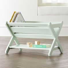 a white wooden bench with books on it