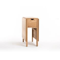 a small wooden table with two drawers on one side and an open drawer on the other