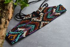 Native American style beaded choker. 100% handmade. Refined and unusual! Clasp - cord, it can adjust the length. Size: Standard Length: 13.2 inch Width: 0.98 inch Made with Czech beads, Nylon thread, cord. These choker can be purchased with the same style of earrings. Please follow the link: https://www.etsy.com/listing/747326761/native-american-beaded-earrings-long Author's design (copy without my permission is prohibited) At your request, the shape, size and color may be changed. Please contac Bead Looming, Beaded Hat Bands, Seed Bead Choker, Native Beading Patterns, Hat Bands, Beaded Hat, Bead Choker, Native American Style, Bead Loom Bracelets