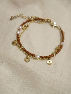 This beaded bracelet gives you the two-in-one layered look with a subtle shimmer of pearl and pops of gold. Perfect for adding to your favorite stack of layered wrist accessories. Seed beads, freshwater pearls, and brass 7" length Made fair trade in India by one of our longstanding production partners Pretty Earrings Dangle, Amber Bead Necklace, Wrist Accessories, Floral Studs, Silver Ring Set, Amber Beads, Gold Ring Sets, Earring Tree, Minimal Jewelry