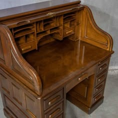 an antique wooden desk with drawers on it