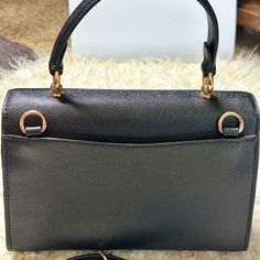 This Beautiful And Rare Coach Tilly Top Handle Satchel Bag Comes In Classy Black Color. It's Crafted From Rich Top Quality Textured Crossgrain Leather And Features A Middle Compartment With Zippered Closure, Gold Tone Signature Hardware, And A Signature Hand Tag. Superior Quality Craftsmanship With A Sleek Silhouette, Attractive Stitching And Many Other Details Gives This Bag A Unique And Classy Look. Top Handle And Long Crossbody/Shoulder Strap Offer Versatile And Comfortable .Nwot High-end Black Flap Bag With Gold-tone Hardware, High-end Black Satchel With Removable Pouch, High-end Black Flap Bag For Travel, High-end Black Top Handle Evening Bag, High-end Black Satchel Flap Bag, Black High-end Satchel Flap Bag, Designer Black Flap Bag With Top Carry Handle, High-end Black Satchel With Detachable Handle, High-end Black Top Handle Flap Bag