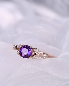 A 1 carat 6mm round Cut Natural Amethyst ring Accent stones: white CZ The stones of the ring can be replace with other different kinds of gemstone such as morganite, aquamarine, amethyst, citrine, white CZ, pink CZ,etc. If you want to customize your own personal ring, please feel free to contact with me. (925 sterling silver white/yellow/rose gold plated or solid 14k white/yellow/rose gold are available) 14 days money back guarantee. Cluster Ring With Round Cut Birthstone For Anniversary, Elegant Round Amethyst Birthstone Ring, Elegant Amethyst Cluster Ring For Wedding, Purple Cubic Zirconia Birthstone Ring, Elegant Amethyst Birthstone Ring, Purple Round Birthstone Ring For Wedding, Yellow Gold Amethyst Ring With Diamond, Amethyst Diamond Ring In Yellow Gold For Wedding, Diamond Birthstone Cluster Ring, Round Shape