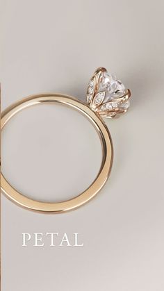 an image of a diamond ring with the word petal written below it in white and gold