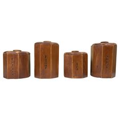 three wooden canisters sitting next to each other