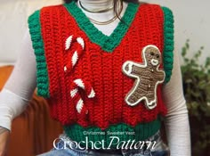 a woman wearing a crocheted christmas sweater with a gingerbread man on it