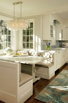 an image of a kitchen with white cabinets and wood flooring on the phone screen