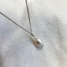 A stunning single, cultured Akoya pearl pendant necklace, on a sterling silver chain. * 6.5mm cultured Akoya pearl  * 2mm crystal (don't like the crystal? Message me)  * 16" / 40cm sterling silver rope chain * boltring clasp * classic minimalist design  A truly beautiful ivory white Japanese Akoya pearl with neutral creams in its fabulous natural lustre. The tiny genuine crystal adds a touch of sparkle. Running freely on a simple sterling silver chain, this pearl pendant necklace is perfect for Classic Pearl Necklace With Pearl Pendant For Anniversary, Classic Pearl Pendant Necklace For Anniversary, White Solitaire Pendant Necklace With Delicate Chain, White Pearl Necklace With Delicate Round Pendant, White Pearl Necklace With Delicate Chain And Round Pendant, White Solitaire Necklace With Delicate Chain For Anniversary, Classic White Pear Solitaire Necklace, Anniversary White Solitaire Necklace With Delicate Chain, Minimalist Silver Pearl Charm Necklace