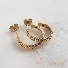 Elevate your style with our Minimalist Vintage Gold Hoop Earrings. These small, lightweight earrings feature a unique etched design, perfect for any occasion. The shimmering gold finish adds a touch of antique charm, while the secure huggie style ensures a comfortable fit. Ideal as a unique gift or a stylish addition to your jewelry collection. 💎 Finely Crafted Jewelry. Made by master goldsmiths in Istanbul in our workshop. ❤️ Enjoy 18k gold for Less! What you see is gold, what touches your skin is 18k gold. 🚚 100% FREE DOMESTIC U.S. SHIPPING ✓ Instant glamour and comfort ✓ Unique etched design for a standout look ✓ Secure huggie style ensures all-day wear ✓ Shimmering gold finish for elegance and durability ✓ Lightweight and small, perfect for any occasion HOW TO ORDER Add item to cart. Scrollwork Design, Minimalist Vintage, Etched Designs, Handcrafted Artisan Jewelry, Lightweight Earrings, Light Weight Earrings, Gold Hoops, Crafted Jewelry, Chain Earrings