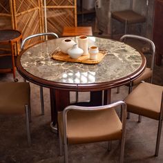 a marble table with chairs around it