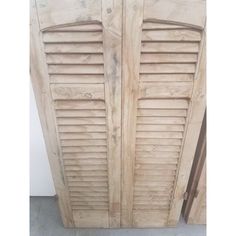 two wooden doors with shutters on each side