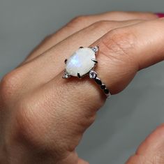 Elevate your style and gift enchantment with our Moonstone Ring This exquisite piece showcases the captivating beauty of moonstone, known for its iridescent play of colors. It's more than a statement piece; it's a meaningful gift that captures the essence of mystique and elegance. 🔸Adjustable band 🔸10mm stone size 🔸Color may vary according to lighting 🔸Silver 925 We offer  🔸Fast shipping  🔸Free shipping for eligible orders  🔸Polishing cloth  🔸Free item on orders of 100€ 🔸Gift box 🎁 🔸Great customer service                                 Moonstone is cherished for its unique ability to shimmer with an otherworldly glow, believed to enhance intuition and provide protection. Its captivating display of colors makes it a timeless choice for jewelry that stands out and carries both be Silver Moonstone Promise Ring With Accent Stones, Silver Moonstone Promise Ring With Prong Setting, Diamond White Moonstone Promise Ring, Moonstone Round Cut Ring For Gift, Gift Moonstone Ring With Round Cut, Gift Moonstone Ring With Center Stone In Sterling Silver, Round Cut Moonstone Ring Center Stone For Gift, Promise Rings With Birthstone And Moonstone, Gift Moonstone Rings In Diamond White