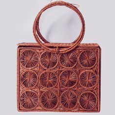 Hand woven bag in iraca palm, designed with a rectangular shape with double handle. Style it with punchy colour combos for a bold and glamorous take on fashion. This product is packaged in an eco friendly box Made in Colombia Available in light brown and navy blue  Composition: Woven Iraca Palm  See-through bag style Dimensions: 9.8 x 7.8 x 3.1 in Bolso tejido a mano en palma de iraca, diseñado con forma de baúl, con aro para sostener con la mano o llevar en el antebrazo. Incluye pañoleta (diseñ Chic Rectangular Beach Bag With Detachable Handle, Rectangular Palm Leaf Beach Bag For Travel, Rectangular Box Bag With Detachable Handle For Vacation, Vacation Rectangular Box Bag With Detachable Handle, Vacation Box Bag With Detachable Handle, Natural Square Box Bag For Vacation, Square Natural Straw Bag With Detachable Handle, Eco-friendly Rectangular Crochet Bag With Top Handle, Rectangular Straw Bag With Bamboo Handle For Vacation