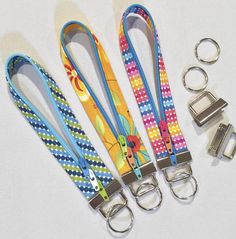 four lanyards and two key chains on a white surface