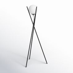 a black and white floor lamp sitting on top of a table