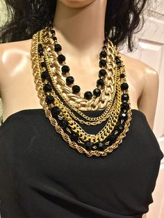 Made in USA. Designed and made by Mirela Skikic Voss - Louisville, KY Elegant, classy, and trendy piece of jewelry for every occasion. Made of several different gold and black color chains, and of glass black beads. It opens/closes behind the neck with a lobster clasp. Excellent gift idea. Black Metal Jewelry With Chunky Chain, Trendy Black Chain Link Jewelry, Elegant Black Chain Link Jewelry, Black Chain Link Necklace, Black Chunky Chain Link Jewelry, Multi-strand Chunky Chain Jewelry For Parties, Trendy Black Jewelry With Gold Chain, Black Multi-strand Costume Jewelry Necklace, Black Multi-strand Costume Jewelry