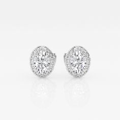 These imperial looking oval stud earrings are one of our best sellers. Large oval cut lab grown diamonds with a halo of round diamonds are a true amalgamation of style and glamor. Classic Halo Diamond Earrings In Diamond White, Dazzling Oval Brilliant Cut Diamond Earrings, Formal Halo Diamond Earrings With Lab-grown Diamonds, Formal Halo Lab Grown Diamond Earrings, Classic Moissanite Diamond Earrings In Halo Setting, Classic Moissanite Diamond Earrings With Halo Setting, Oval Brilliant Cut Diamond Earrings, Classic White Diamond Earrings With Halo, Dazzling Oval Diamond Earrings With Prong Setting